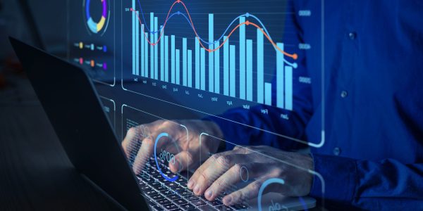 Data analyst working on business analytics dashboard with charts, metrics and KPI to analyze performance and create insight reports for operations management.